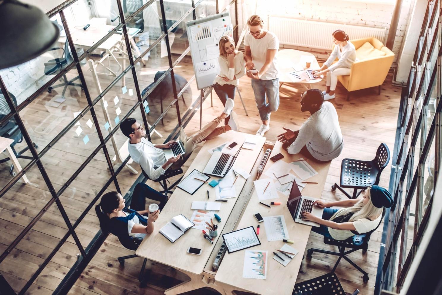 Workshop participants analyzing SEO data on laptops during collaborative learning session